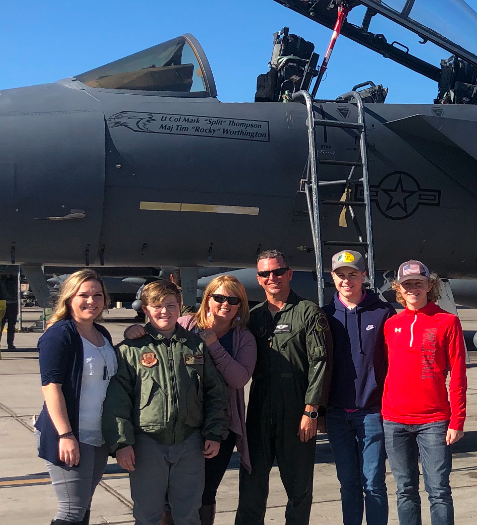 family in front of plane